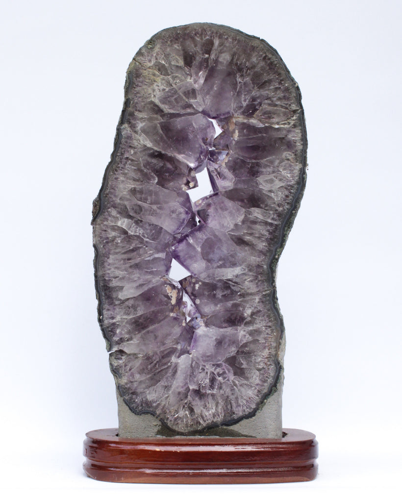 Amethyst slice with calcite deposits and a baroque natural forming pearl.
