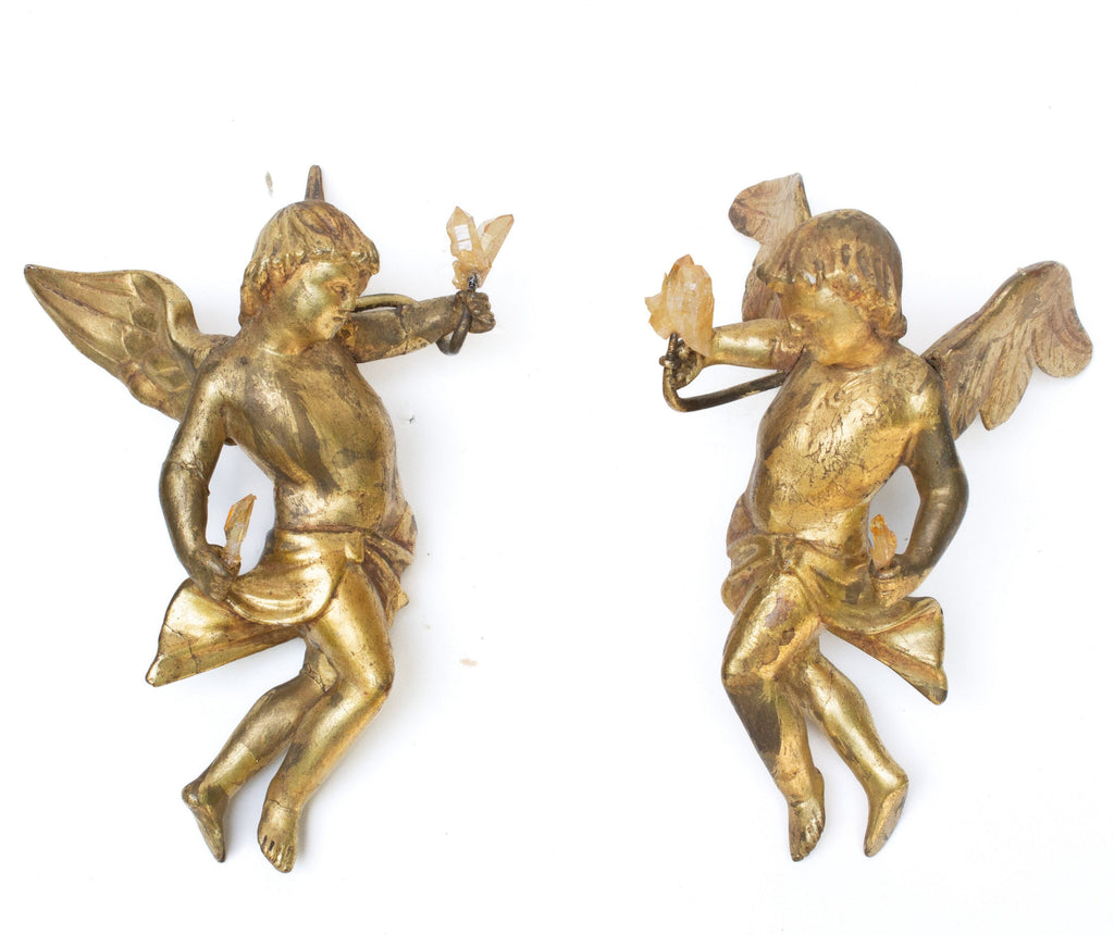 Pair of 18th century Italian hand-carved gold leaf angels with golden quartz crystals. The sculptural pair have the original metal wall hangers to be hung on the wall.