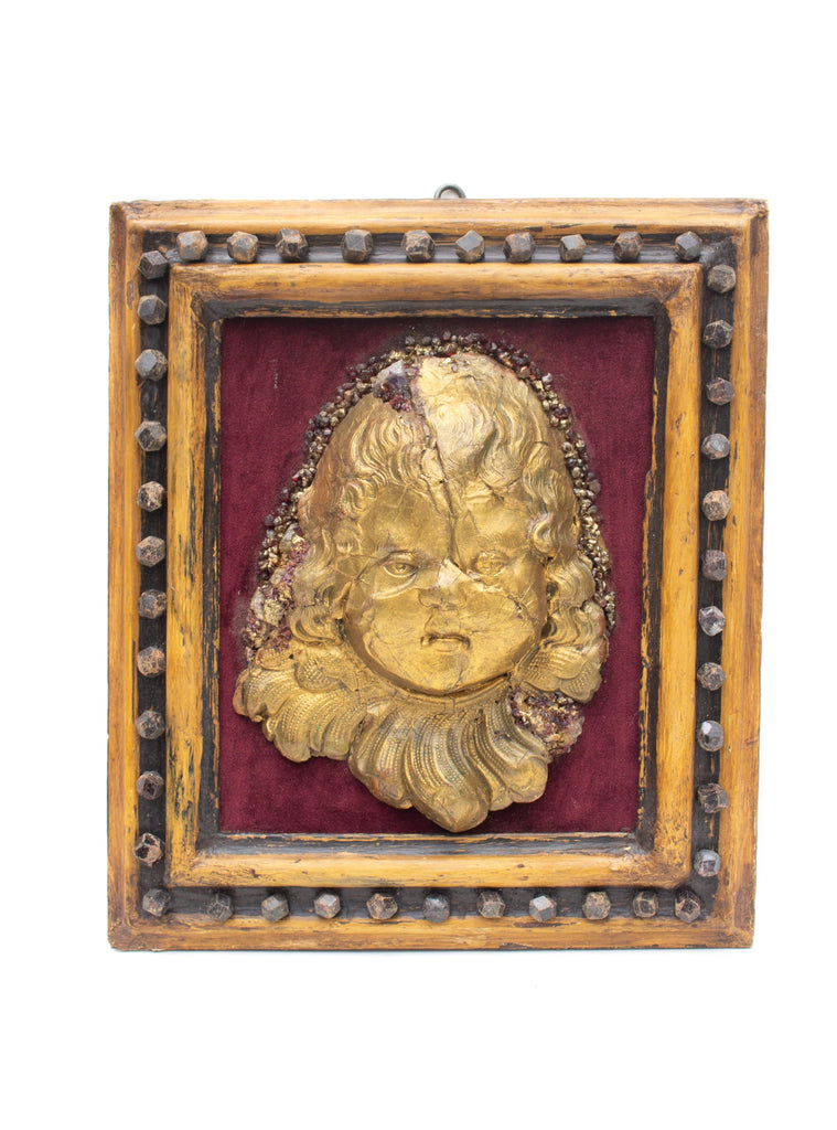 Framed 18th century Italian gold leaf angel head 'putto' wall relief sculpture with burgundy velvet and adorned with rubies and garnets.