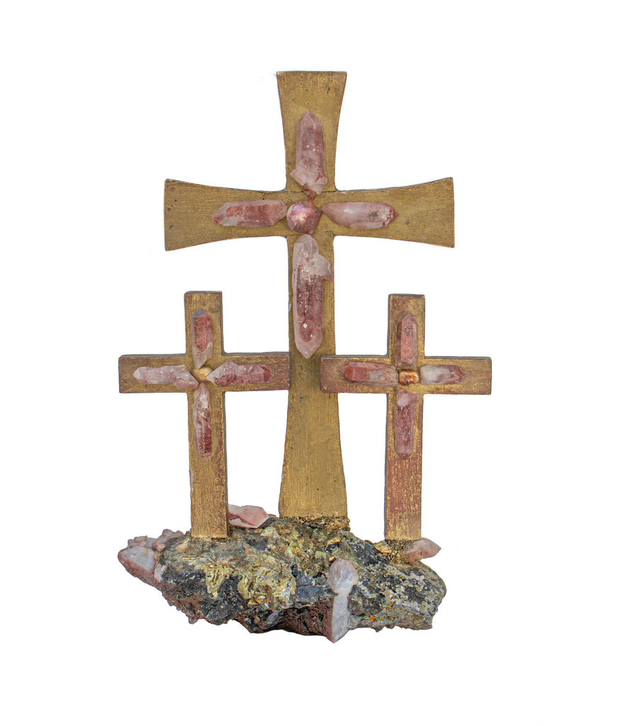 18th century Italian mecca crucifix with red phantom crystal quartz points, natural-forming casting metal, and a baroque pearl. It is sitting on a pyrite in matrix with red phantom crystal quartz points.