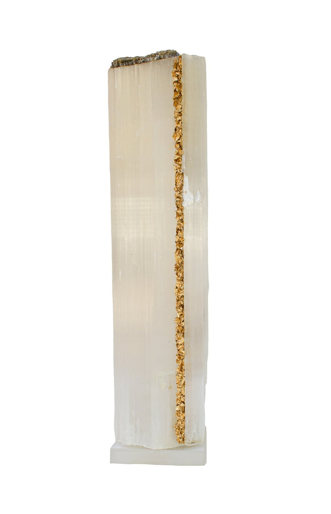 Ruler Selenite with gold leaf on a Lucite base. Selenite logs are single, prismatic selenite crystals from Morocco that were formed in extensive beds by the evaporation of ocean brine. This mineral is characterized by a silky, pearly luster called satin spare. It is then subtly lined with gold leaf on one side which contrasts beautifully with the sleek selenite.