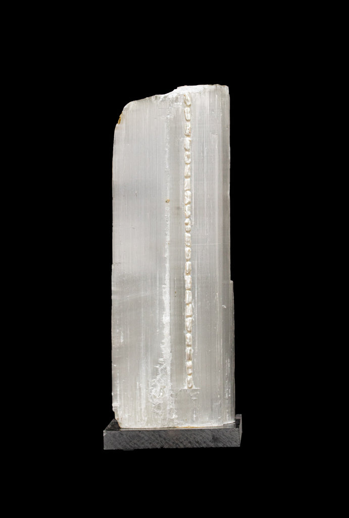 Ruler Selenite with natural forming baroque pearls on a lucite base.